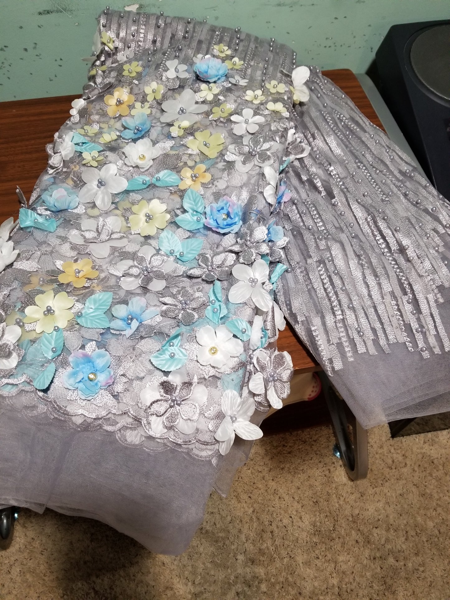 New arrival french lace fabric. Beautiful 3D flower border made to perfection. Ideal for evening gown, or Nigerian traditional wedding outfit. This color is light gray mix with blue and white petals. Sold per 5yds