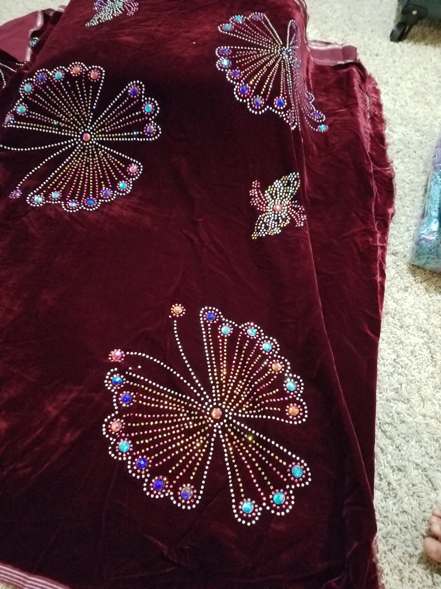 Clearance Wine Velvet wrapper. Original quality beaded and stoned. Use for Nigerian Bridal wrapper/traditional weddings ceremony. Igbo/Edo Bride wrapper in velvet. sold per 2.5yds, price is for 2.5yds. Beautiful butterfly stone work. Made with quality