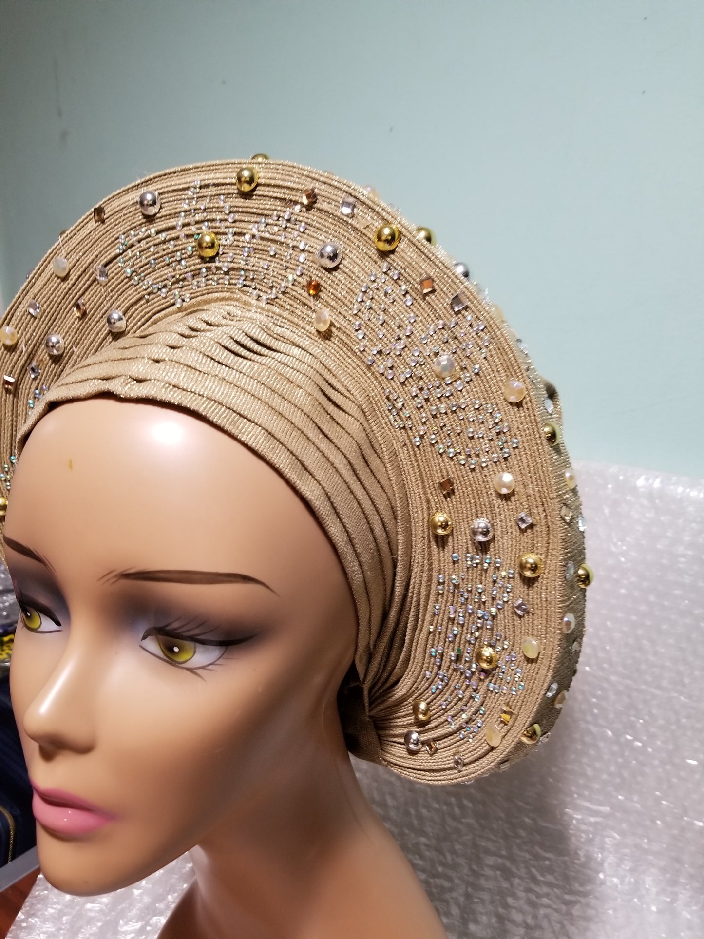 Beautiful champagne gold Auto-gele made with quality Aso-oke. Beaded and stoned work front and back to perfection. One size fit, easy to adjust for fit and knot at the back to secure your gele. This is true original auto gele