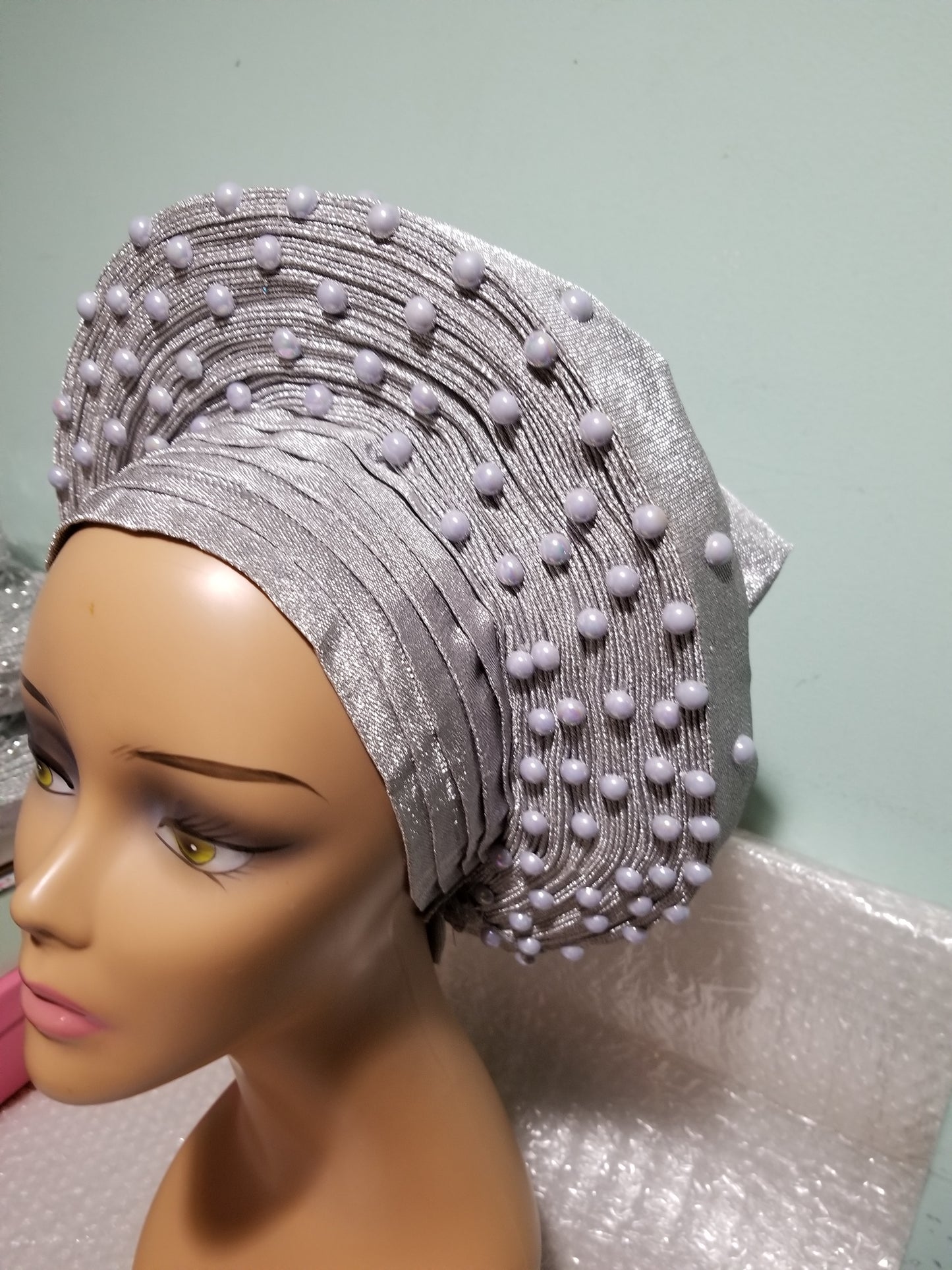 New arrival: Nigeria auto-gele in Silver. Made with quality aso-oke/woven in Nigeria. made into gele. beaded and stoned. Party ready in less than 5 minutes. One size fit, easy adjustment at the back