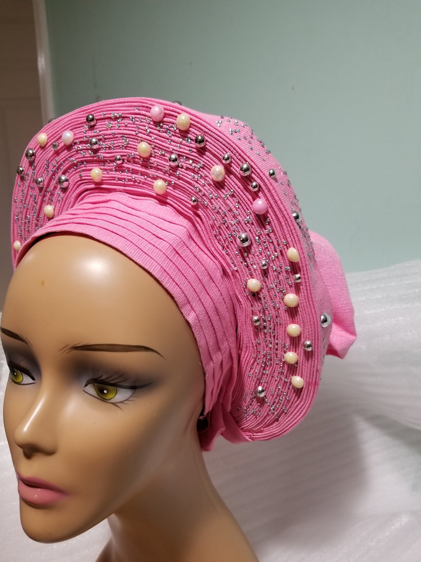 Sweet baby pink Auto-gele made with quality Aso-oke. Silver stoned work to perfection. One size fit, easy to adjust for fit and knot at the back to secure your gele. This is true original auto gele