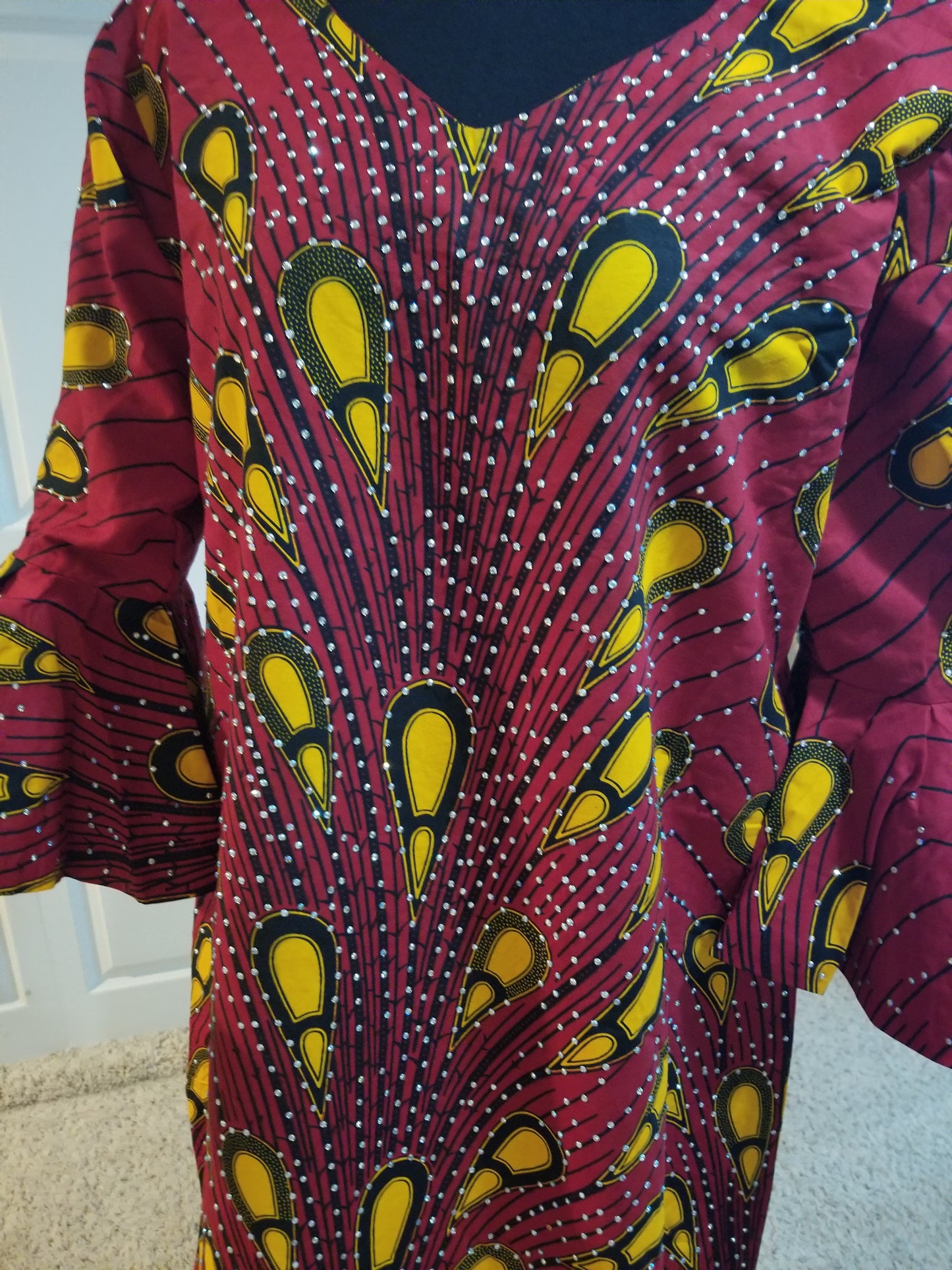 Clearance: red Ankara-dress, embellished with shinning Swarovski stones to perfection! Fit Burst 46" and 59" lenght shoulder to floor. Made with Quality hitarget Ankara. Comes with a matching headtie. Flared sleeves