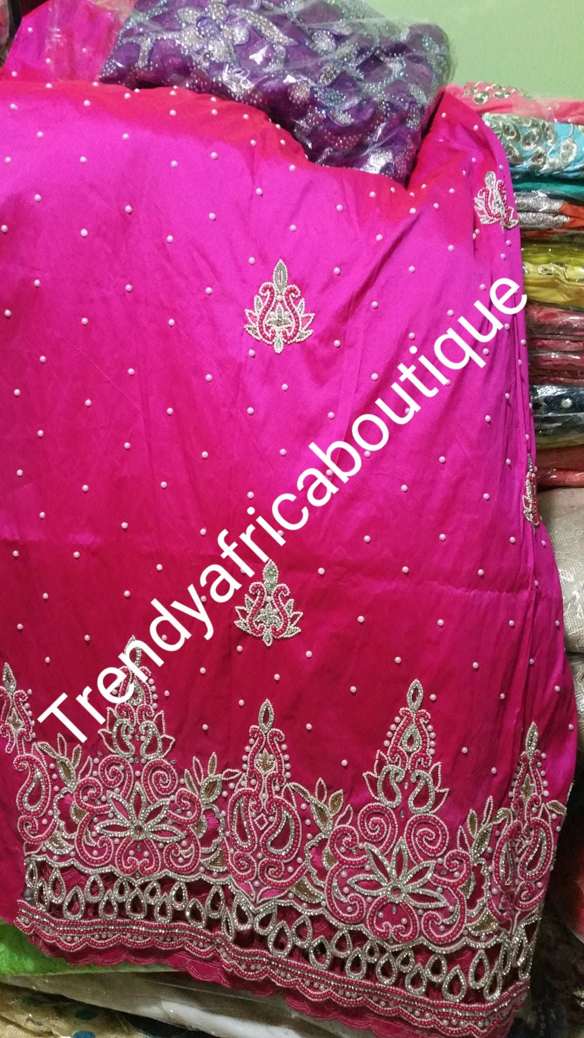 On sale: Heavily Beaded/stoned Igbo traditional celebrant Silk George wrapper with matching net blouse. Fuchsia pink color