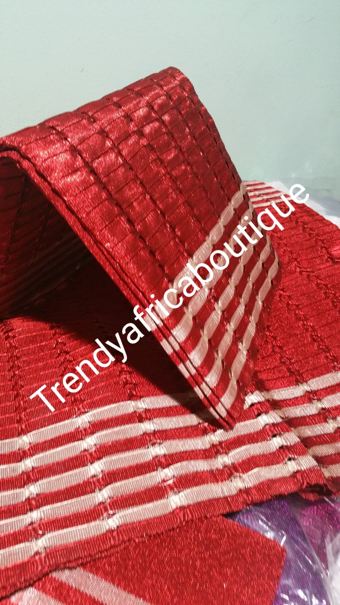 Red/white Nigerian aso-oke gele/ipele with holes and strings. Original quality . Sold as a set of 3pcs. A piece for hubby hat included.