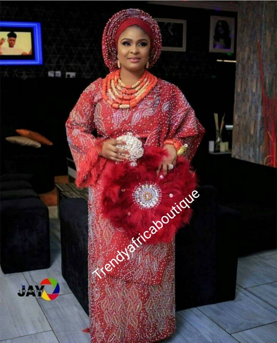 Hand made bead-dazzled with rhinestones. 4pcs custom-made aso-oke set for woman. This color is Tomato red but can be made in any color of your choice. 4pc Gele/ipele, wrapper and buba or fitted blouse. Allow 6-8 weeks processing time