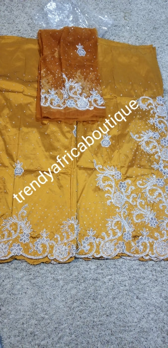 Exclusive design. Gold silk George wrapper beaded and stoned with white/silver. Nigetian traditional wedding George wrapper. Top quality at a special price. Sold 5yds +1.8yds matching net blouse