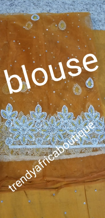 New arrival Gold George wrapper for special occasion. Nigerian traditional wedding/special occasion George. Sold 5yds + 1.8 yards macthing net George. This is simply quality silk George you can't afford to miss