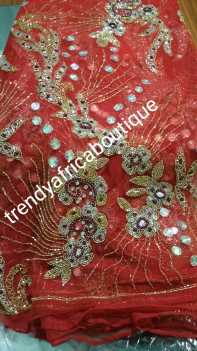 Clearance item: tomato Red Net George wrapper fabric. 6.5yds total. Fully beaded and stoned for making red carpet dresses for Nigerian weddings/ceremonies. Celebrant model wearing same material.