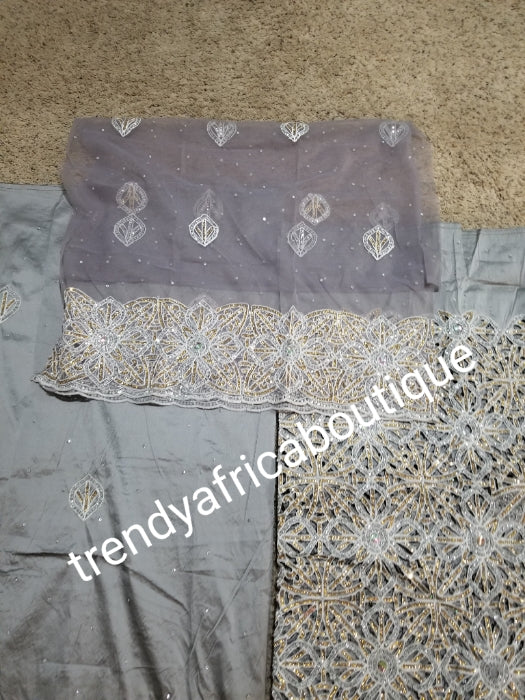 Latest ash/gray VIP hand cut embriodery Silk George wrapper and matching net blouse. Gray George, All Crystal stones to perfection. Quality Guaranteed. 2 wrapper of 2.5yds each and 1.8yds blouse. Nigerian madam George/Igbo Delta women