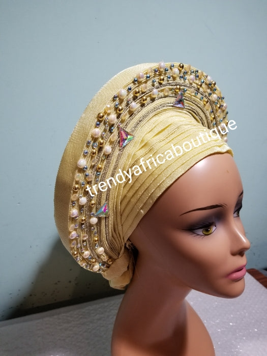 Cream embellished with beads auto-gele. Wahala free gele aleeady made for you. Easy adjustment for proper fit at the back. Original quality from Nigeria.