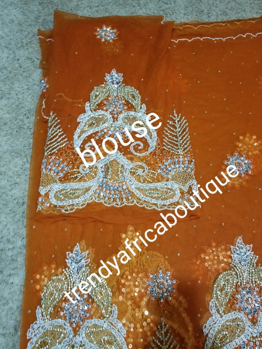 New arrival Gorgeous Igbo Traditional Bridal outfit- quality net George wrapper and matching net for blouse. embellished with dazzling Crystal stones all over. 2 wrapper + 1.8yds net for blouse. Sweet orange net Ideal for Celebrant outfit
