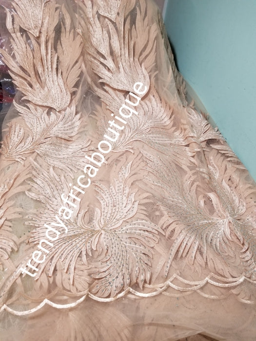 New arrival champagne gold French lace design. Swiss quality embellished with crystal stoned. Sold per 5yds. Nigerian french lace fabric. Rich quality for wedding dresses. For making Nigerian party dresses.
