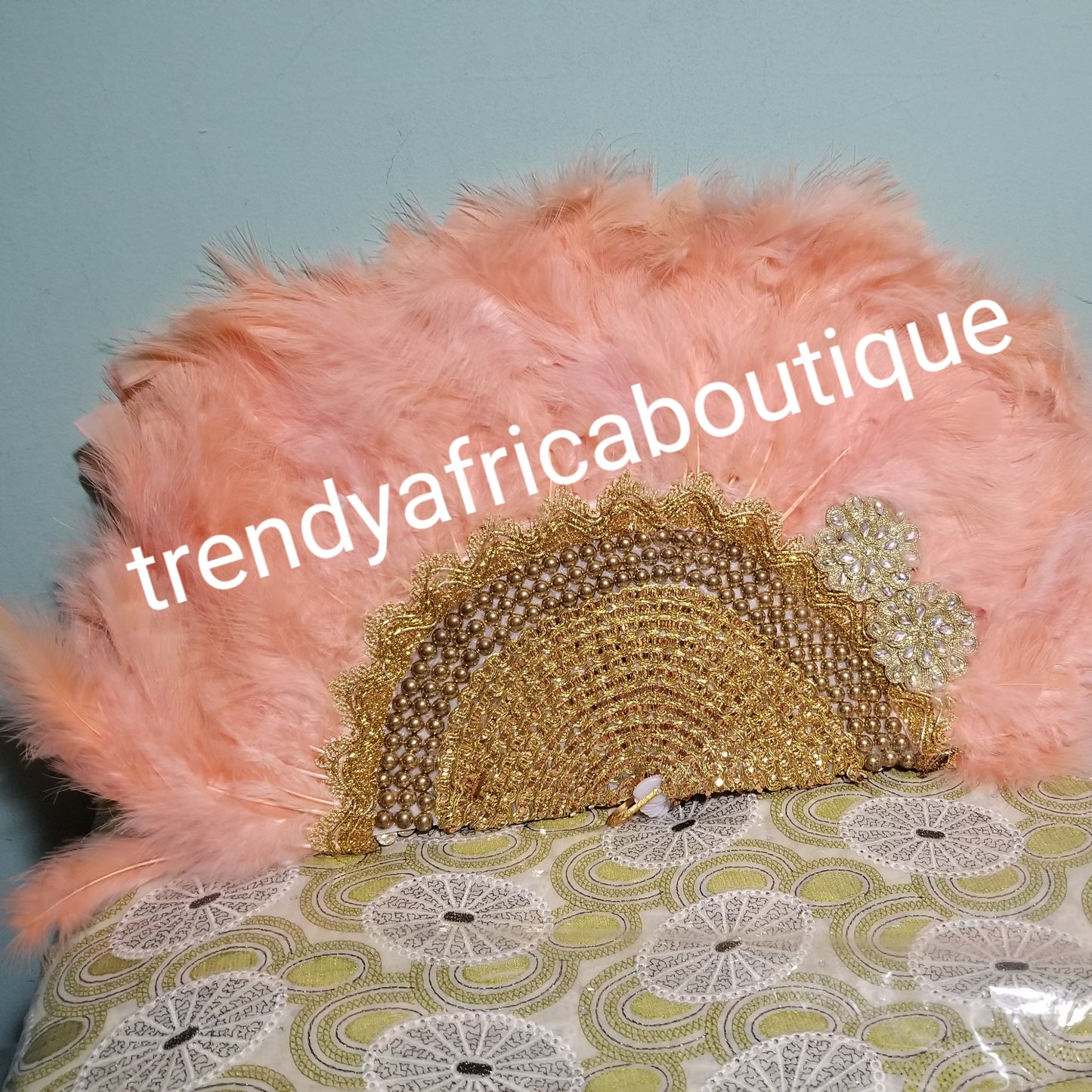 Peach Feather hand fan. Medium size moon shape hand fan Nigerian Bridal-accessories front and back design with gold beads and flower petal. Limited quantity. 19" long + 14" wide. Small handle to hold your fan. Very class
