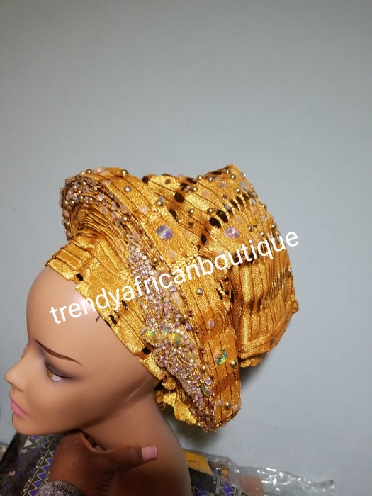 Beaded and stoned Gold Auto-gele made with quality Aso-oke. Beaded and stoned work front and back to perfection. One size fit, easy to adjust and knot at the back to secure your gele. This is true original auto gele