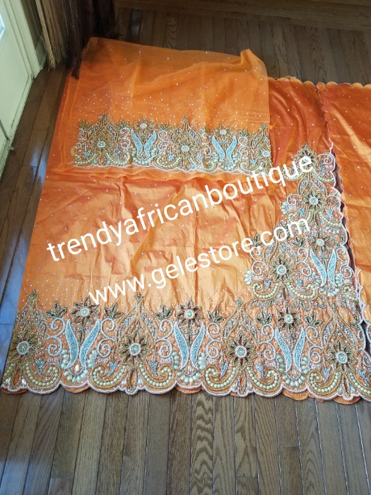 Sweet Orange VIP Hand beaded and crystal Stoned Silk George wrapper, champagne net for blouse. Nigerian, Igbo/Delta traditional wedding out fit. Sold as full 2.5yds with side border design + 2.5yds + 1.8yds matching net for blouse. Quality taffeta silk!
