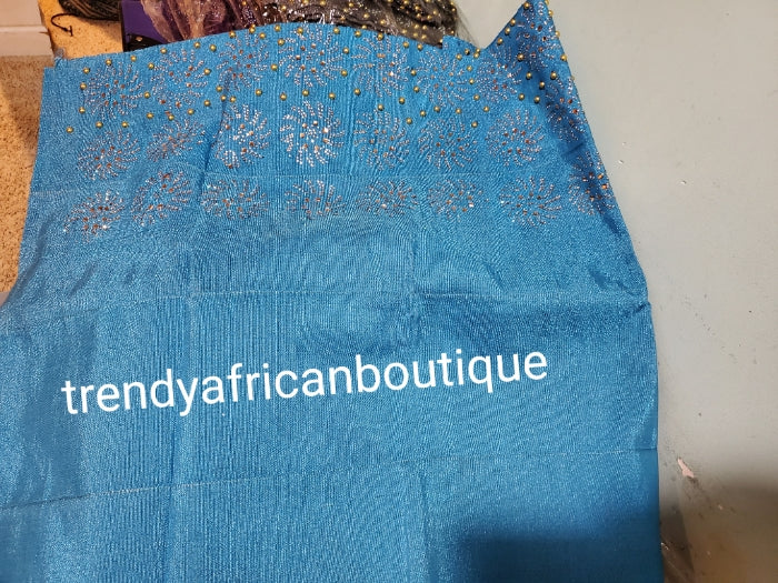 Turquoise blue Bedazzled aso-oke. Nigerian woven traditional Aso-oke for making stylish head wrap. Beaded and Swarovski stones work for perfect headwrap finish. Gele only. Extra wide gele for bigger head wrap. 72" long × 26" wide