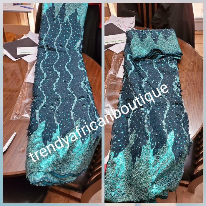 Beautiful mint green/teal french lace fabric with all over sequence. Great quality. Sold per 5yds. Model shown wearing same color