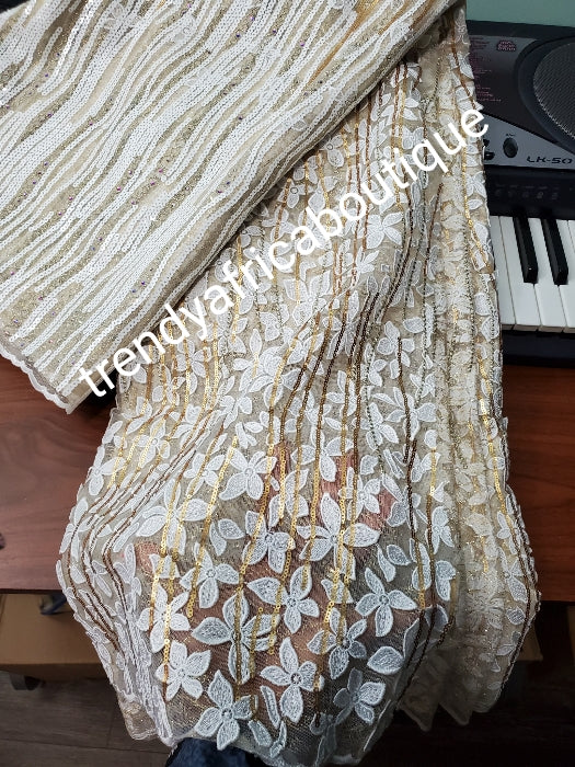 Exclusive unique Organza swiss lace fabric. Embellished with sequence and stones. Big Quality design for wrapper, skirt /blouse. Cream/champagne gold lace fabric sold per 5yds. Nigerian wedding fabric
