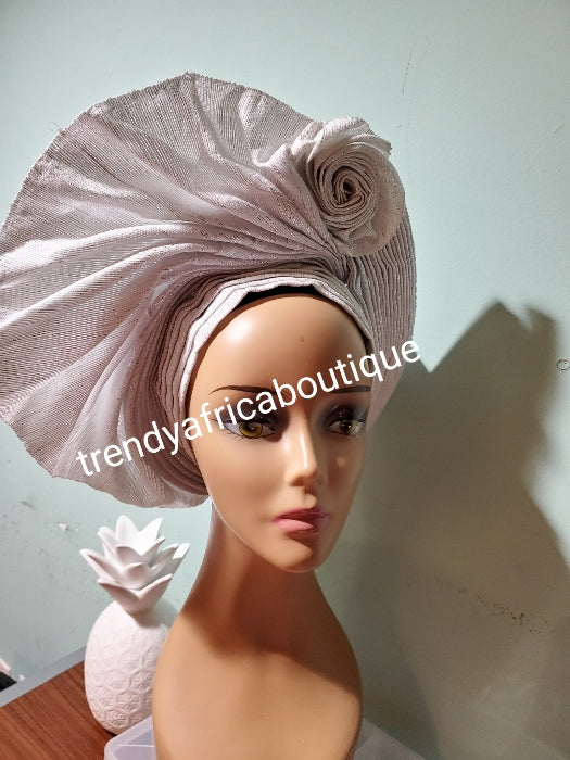 Quality white/silver Auto-gele made with quality Aso-oke. Fan design with side rose for perfect finish. One size fit, easy to adjust for fit and knot at the back to secure your gele. original auto gele