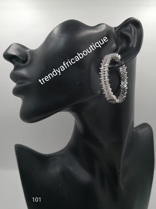 Silver tone hoop earrings with clear crystals in 18k electroplating. Top quality made hypoallergenic. Light weight earrings. Beautiful Dubai silver earrings