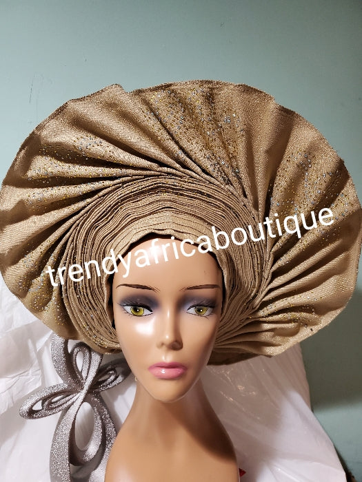 Bold & beautiful champagne gold Auto-gele made with quality Aso-oke. Beaded & stones fan design. One size fit, easy to adjust for fit and knot at the back to secure your gele. This is true original auto gele