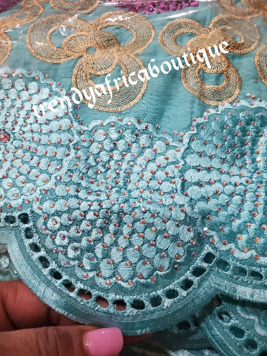 Exclusive swiss lace fabric mintgreen/purple/gold. Nigerian traditional celebrant Swiss lace embroidered with quality tread and all over crystal dazzling stones beautiful design. Sold per 5yds