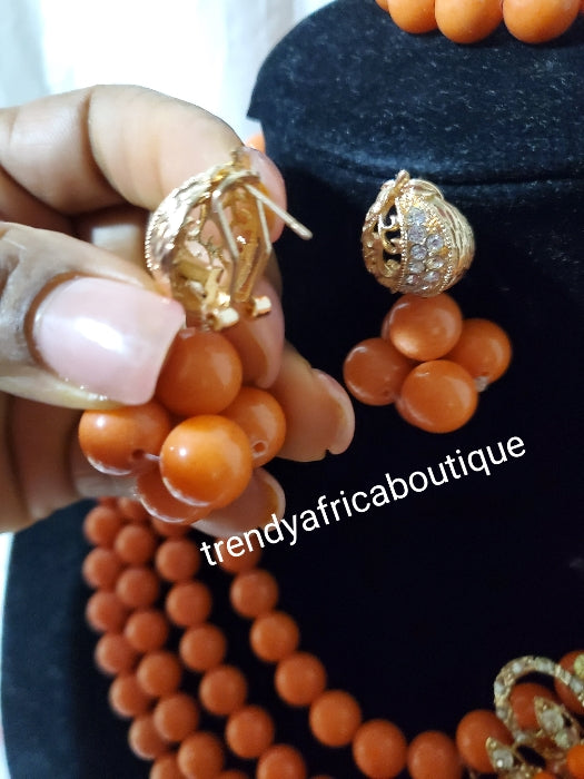 4 layers peach beaded-necklace with a side broach, matching earrings and bracelet. Traditional Bridal wedding bead. Exclusive Nigeria native bead design with gold accessories sold per set. Bridal-accessories