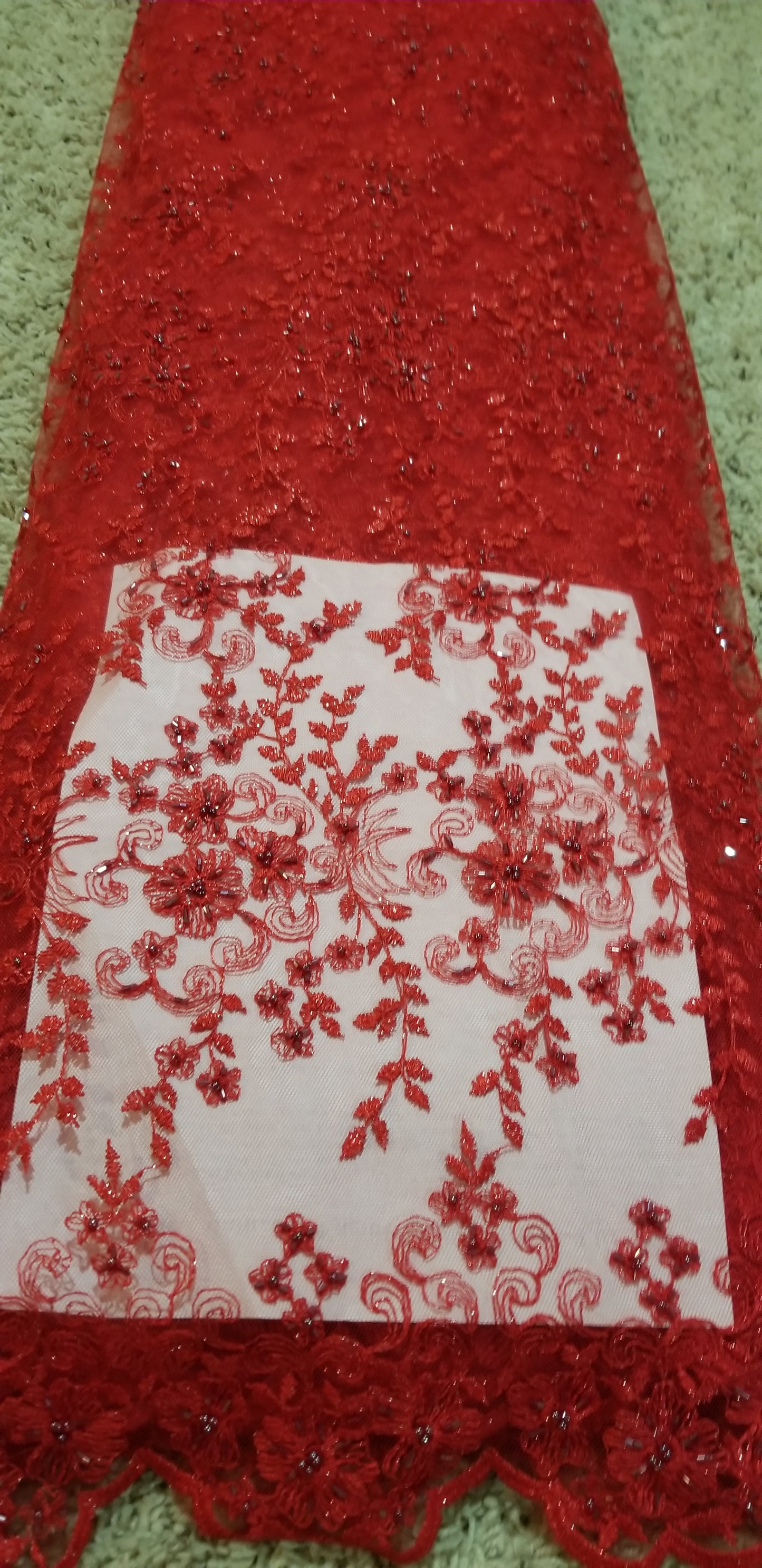 RED Net French lace fabric. Sold per yard.  Beaded and stones design for making wedding/ party dresses. Soft texture fabric. Will require linen. Price is per yard.