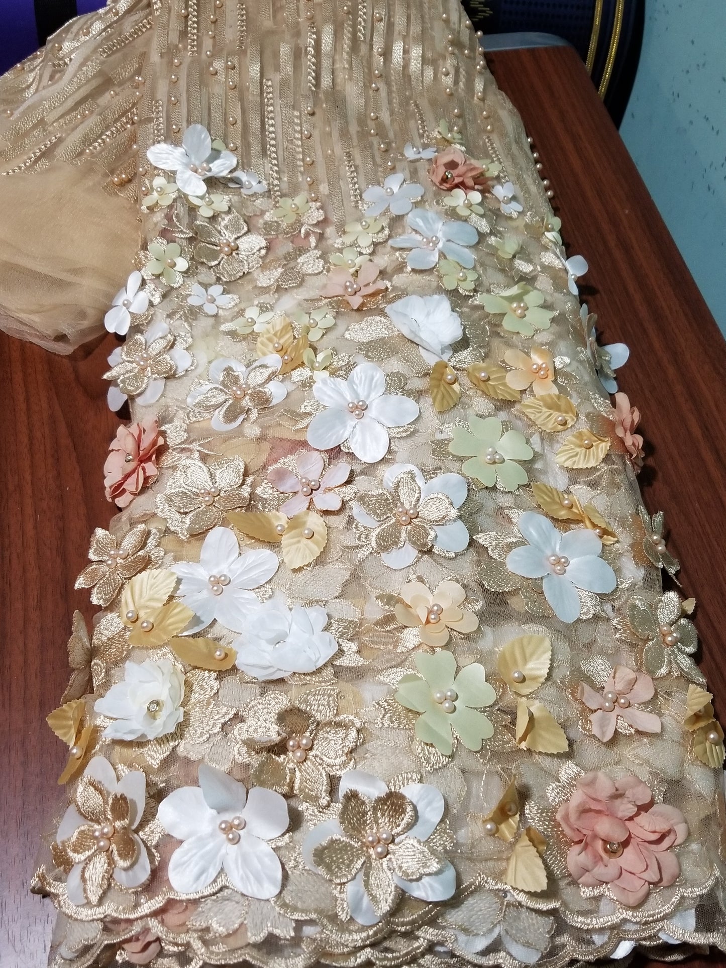 New arrival french lace fabric. Beautiful 3D flower border made to perfection. Ideal for evening gown, or Nigerian traditional wedding outfit. This color is gold with champagn and white petals. Sold per 5yds