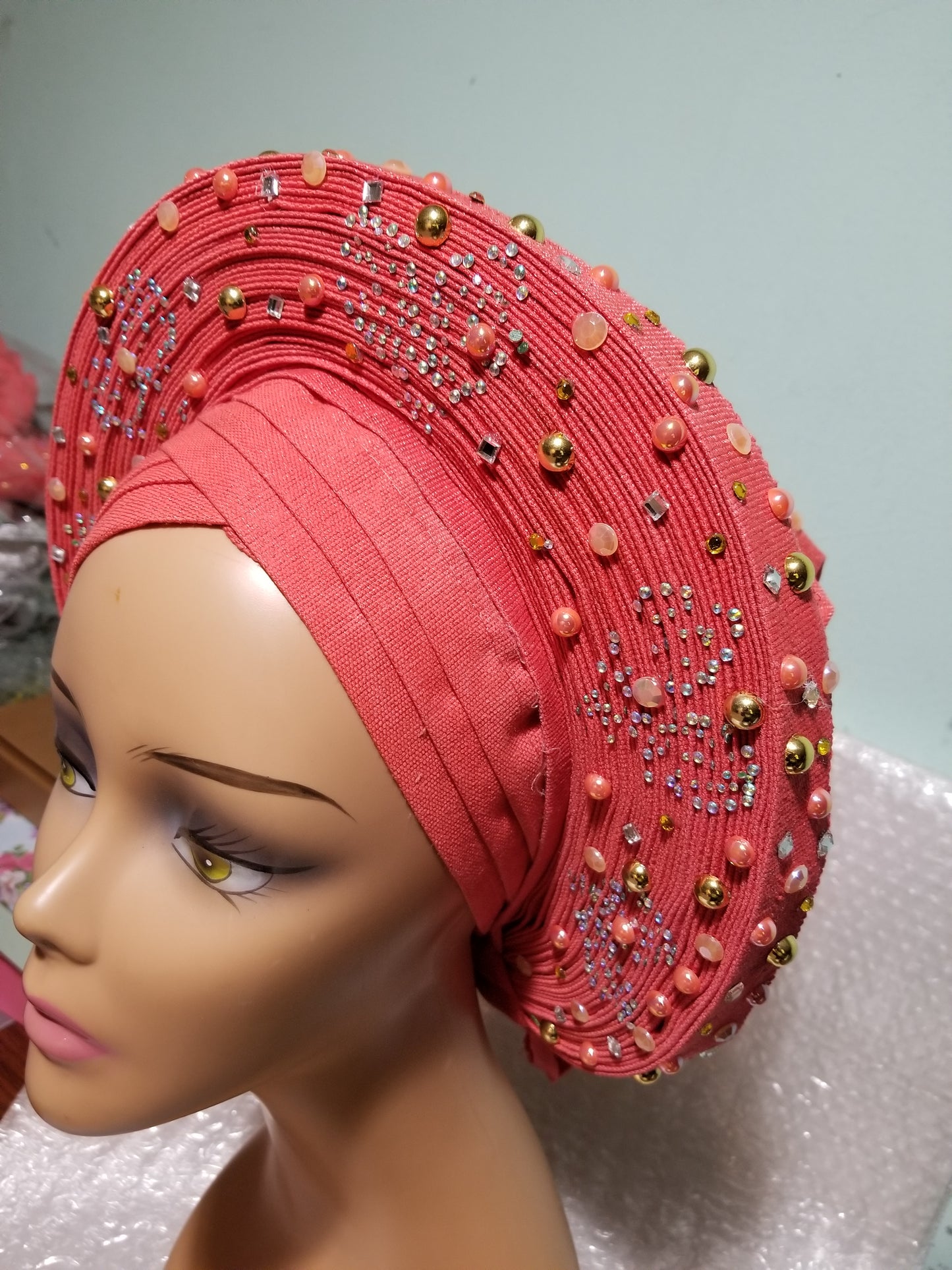 Sweet Coral Auto-gele made with quality Aso-oke. Beaded and stoned work front and back to perfection. One size fit, easy to adjust for fit and knot at the back to secure your gele. This is true original auto gele