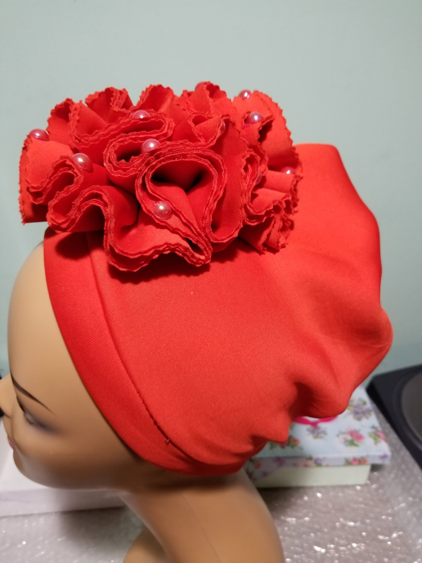 Red color rose design Women-turban. One size fit all turban. Beautiful flower design with a side brooch/beaded and stoned to add decor to your turban