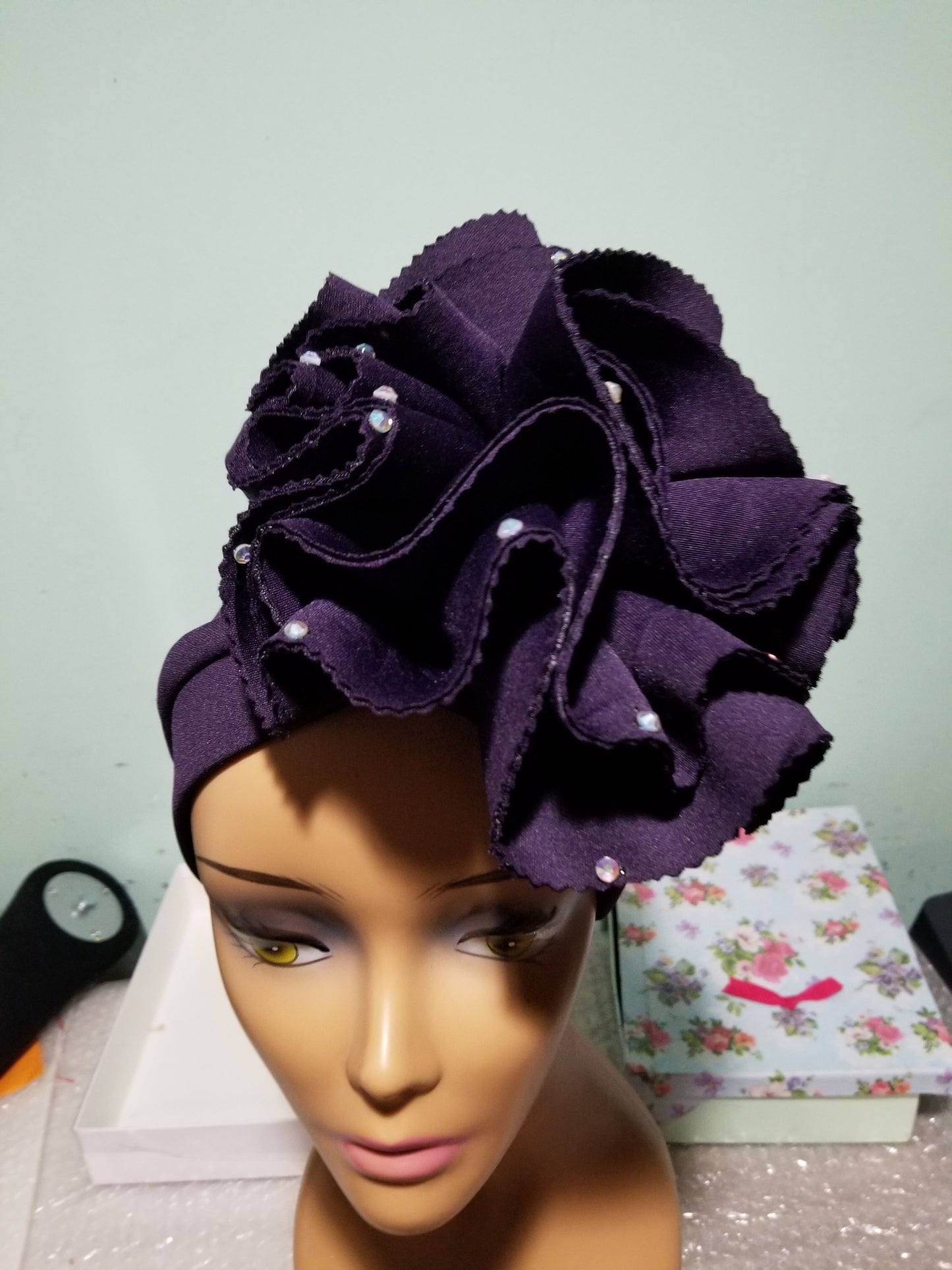 Egg plant color Women-turban. One size fit all turban. Beautiful flower design with a side brooch/beaded and stoned to add decor to your turban