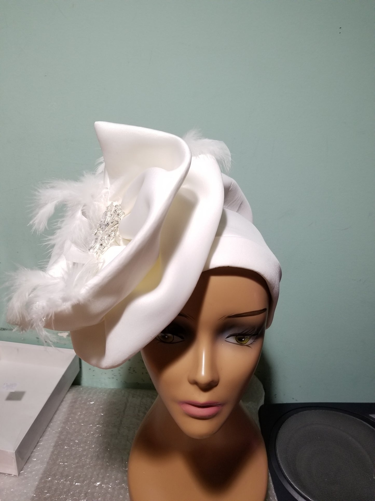 Off White turban design with white feather. Dress it up to chure or party. Women-turban. One size fit all turban. Beautiful design with a side brooch to add decor to your turban