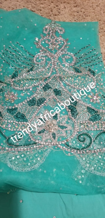 New arrival VIP/Celebrant Silk George wrapper in Mint green. All hand stoned . 5yds and 1.8yds matching net blouse for that special Occasion. Nigerian Traditional Igbo wedding wrapper