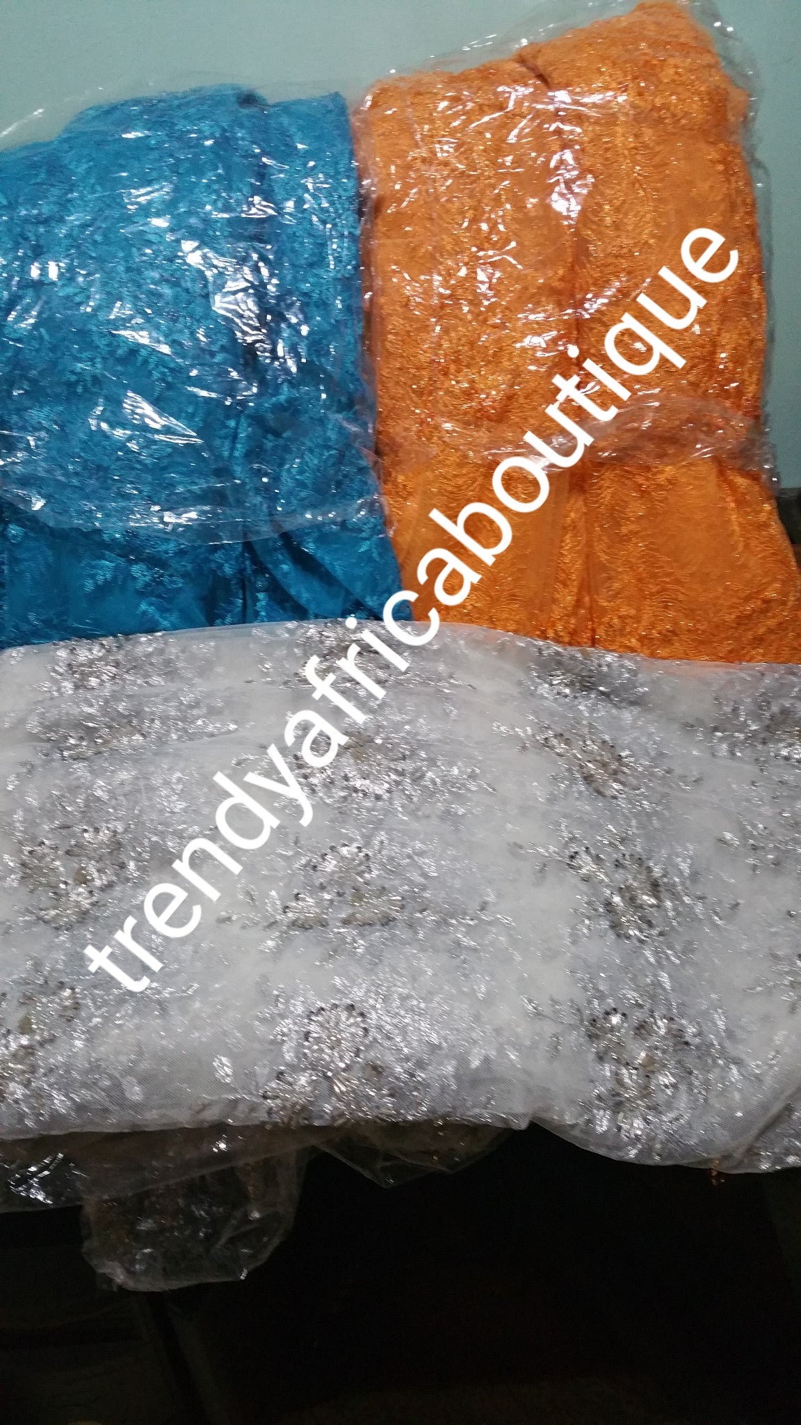 Assorted colors net beaded and stoned fabric for making Blouses for skirt or wrapper.  sold per-yard  36" by 50" wide. Available in royal blue, silver orange and turquoise blue