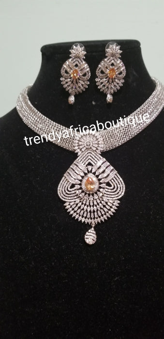 2pcs set 22k electroplated Dubai Gold. Sold as necklace and matching earrings.  Silver set with gold CZ stones