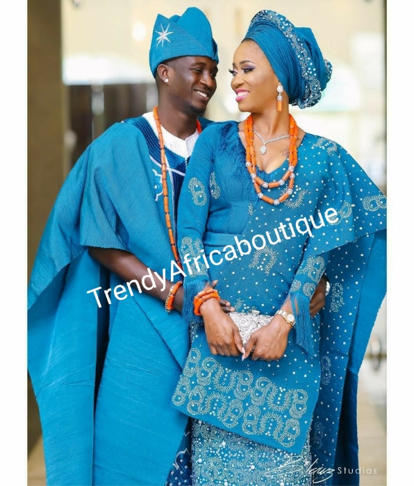 Celebrant Agbada Beaddazzled Aso-oke in turqouise blue. Custom-made design. Make-to-order only. Aso-oke set for man and woman. Can be order for individual only or complet set for couple. 6-8 weeks for production. Nigerian Traditional wedding outfit