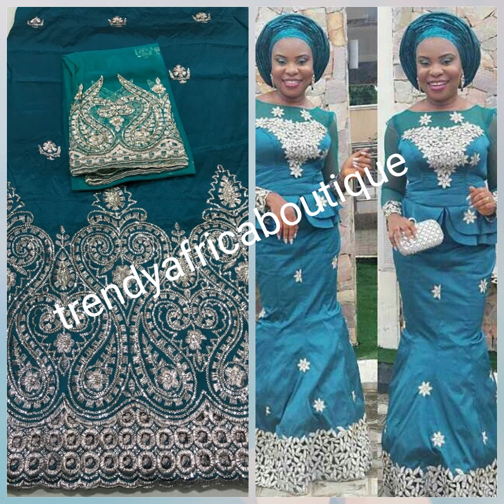New arrival of Teal color Silk embroidery george. Embriodered with gold. Super quality Indian-George for making Aso-ebi dresses, Nigerian party dress. Contact us for group order. Sold as 5yds + 1.8yds matching  net for blouse combo