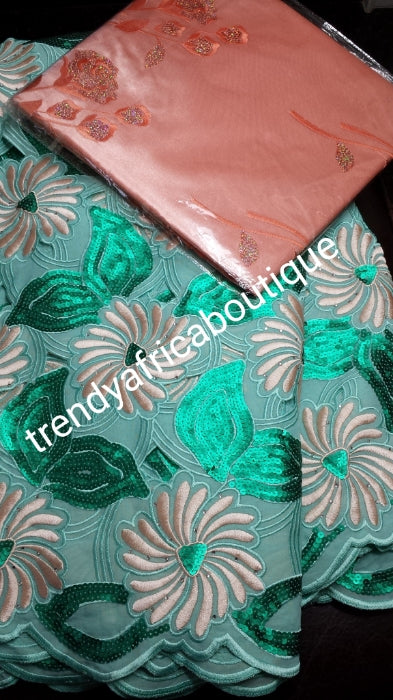 Sale: Top quality swiss lace fabric in Mint green/peach. Swiss voile with beautiful sequence design/ peach embroidery. Nigerian Party lace for high society party. Sold per 5yds with free matching peach headtie. Original swiss made fabric