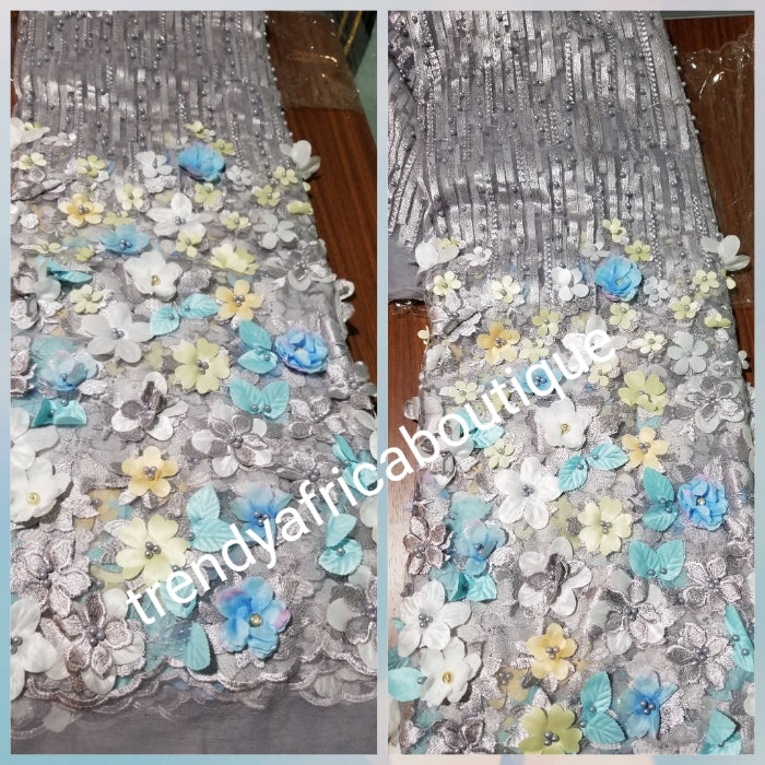 New arrival french lace fabric. Beautiful 3D flower border made to perfection.  Ideal for evening gown, or Nigerian traditional wedding outfit. This color is light gray mix with blue and white petals. Sold per 5yds