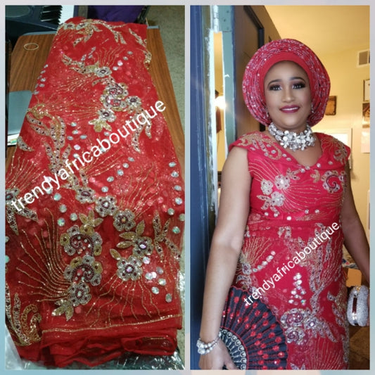 Clearance item: tomato Red Net George wrapper fabric. 6.5yds total. Fully beaded and stoned for making red carpet dresses  for Nigerian weddings/ceremonies. Celebrant model wearing same material.