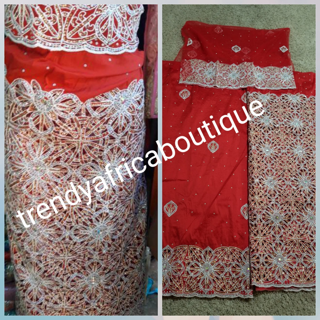 Latest VIP hand cut embriodery Silk George wrapper and matching net blouse. Pepper red George, All Crystal stones to perfection. Quality Guaranteed. 2 wrapper of 2.5yds each and 1.8yds blouse. Nigerian madam George/Igbo Delta women