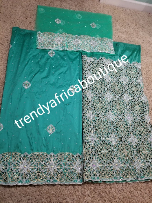 Latest VIP hand cut embriodery Silk George wrapper and matching net blouse. Mint green George, All Crystal stones to perfection. Quality Guaranteed. 2 wrapper of 2.5yds each and 1.8yds blouse. Nigerian madam George/Igbo Delta women