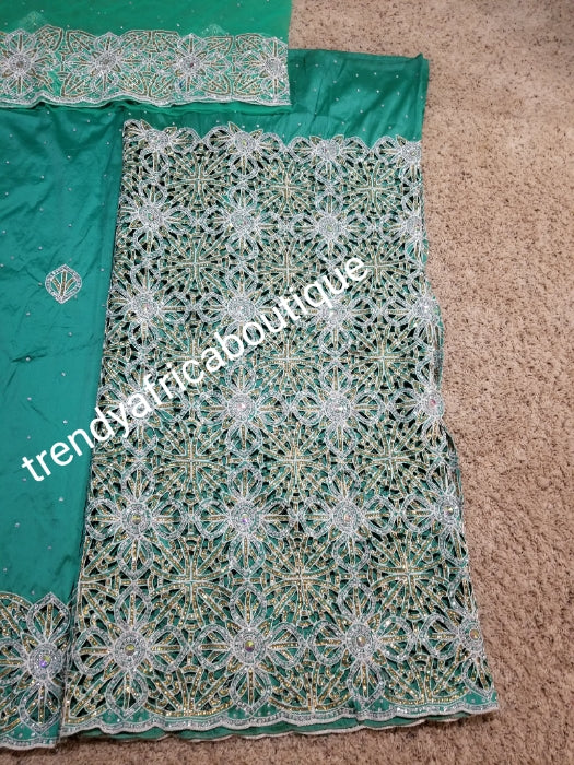 Latest VIP hand cut embriodery Silk George wrapper and matching net blouse. Mint green George, All Crystal stones to perfection. Quality Guaranteed. 2 wrapper of 2.5yds each and 1.8yds blouse. Nigerian madam George/Igbo Delta women
