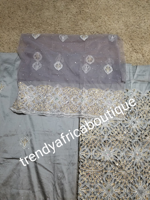 Latest ash/gray  VIP hand cut embriodery Silk George wrapper and matching net blouse. Gray George, All Crystal stones to perfection. Quality Guaranteed. 2 wrapper of 2.5yds each and 1.8yds blouse. Nigerian madam George/Igbo Delta women