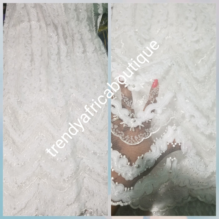 New arrival white/white net French lace fabric. Quality lace stoned with pearls and sequins. Sold per 5yds. African french lace fabric. Rich quality for wedding dress