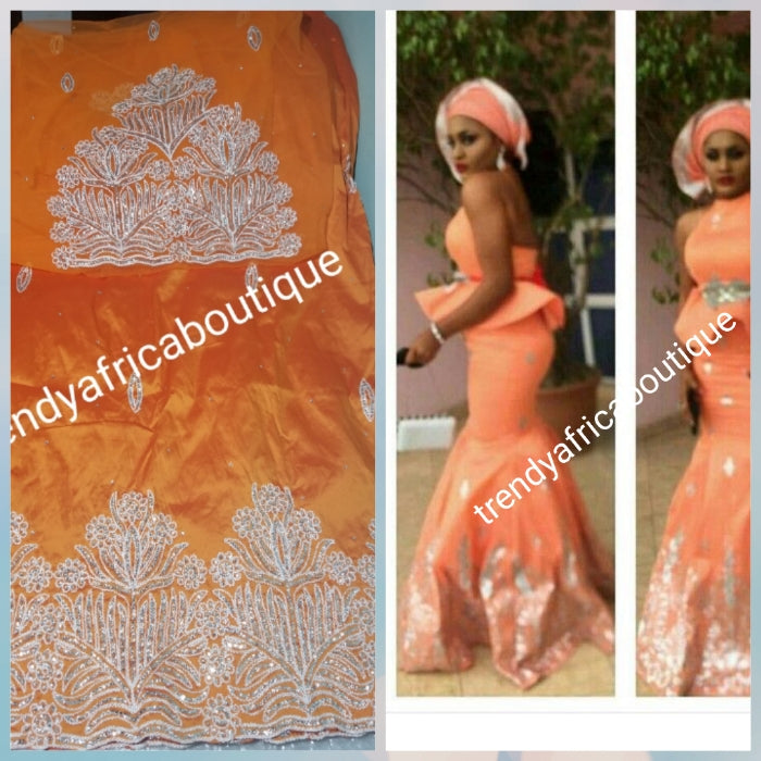 Original quality taffeta George wrapper. beautiful orange embriodery/crystal stones George Wrapper. dazzling crystal stones to perfection. Small-George. Model wearing similar George. Aso-ebi Georges
