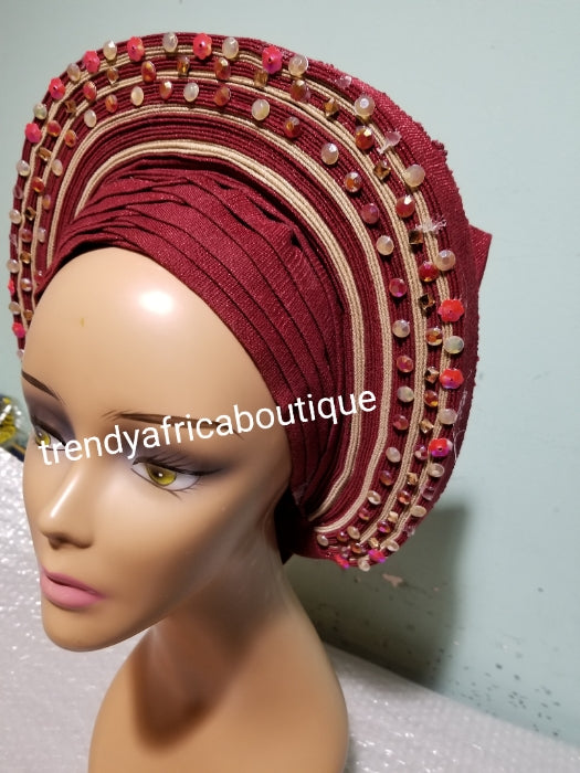 Wine/champagne aso-oke embellished with beads/stones auto-gele. Wahala free gele already made for you with finest quality aso-oke. Easy adjustment for proper fit at the back. Original quality from Nigeria.