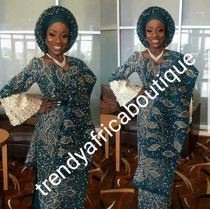 Custom-made Nigerian Traditional Wedding/celebrant Aso-oke 4pcs set: Wrapper, fitted blouse, gele, Ipele beadazzled aso-oke. Make-to-order. This is emerald green color, high grade Swarovaski stones. 6-8 weeks for order processing.