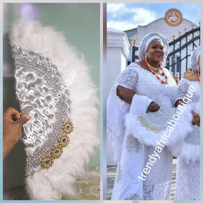 Back in stock. Pure White/silver Feather hand fan. Large moon shape hand fan Nigerian  Bridal-accessories front and back middle design with beads and flower petal. Limited quantity. 25" long + 14" wide. Small handle to hold your fan. Very class